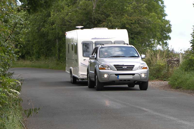 Touring caravan towed by Kia